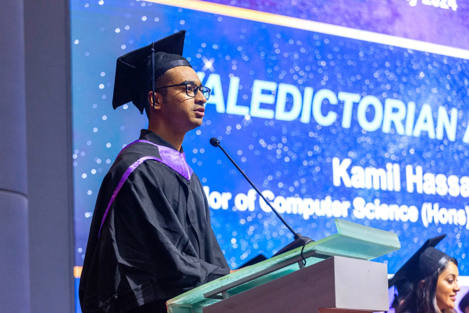 Kamil Hassan delivering the valedictorian speech at APU graduation