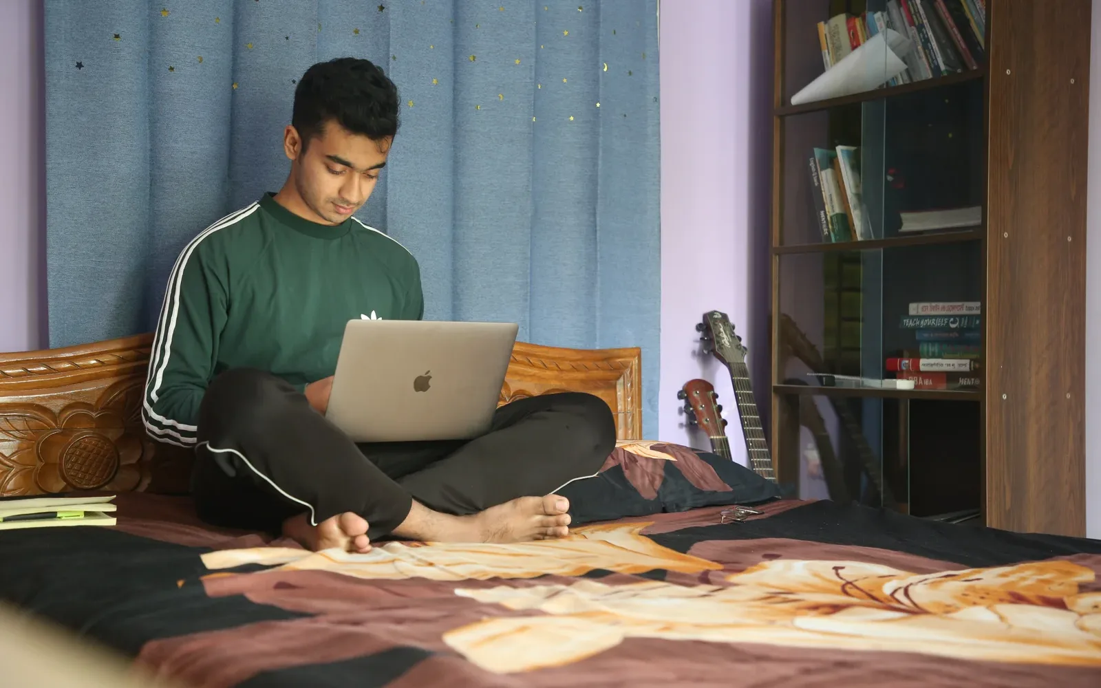 Kamil Hassan coding on a laptop
