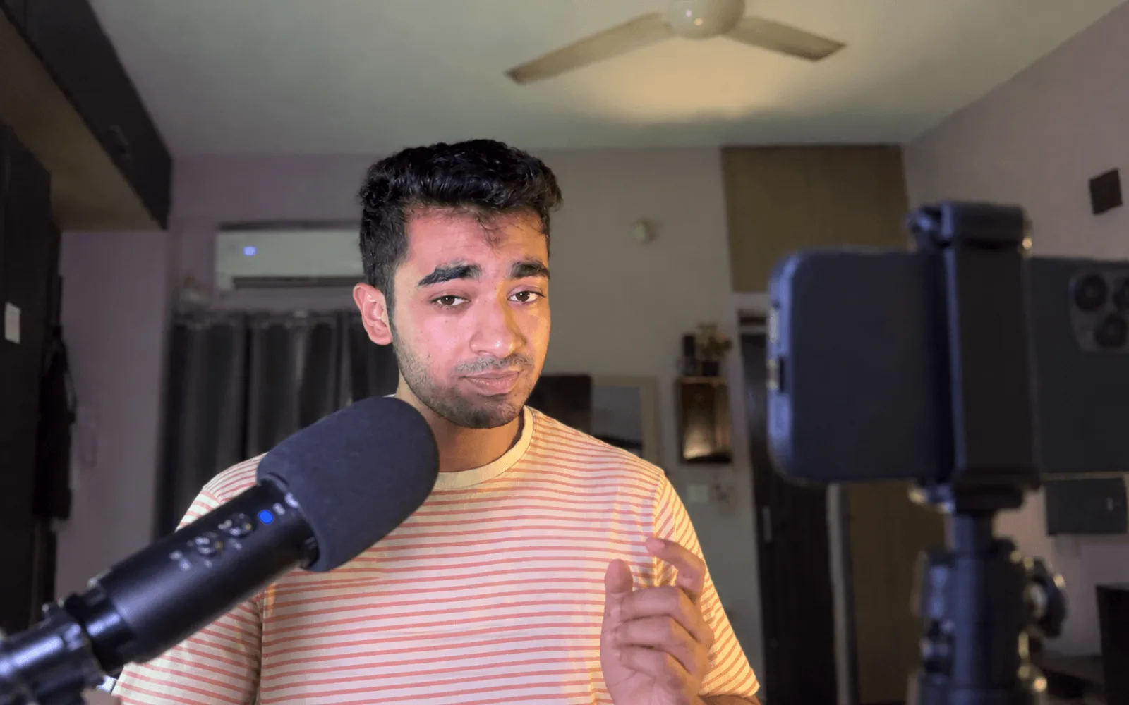 Kamil Hassan recording a video with a microphone and camera
